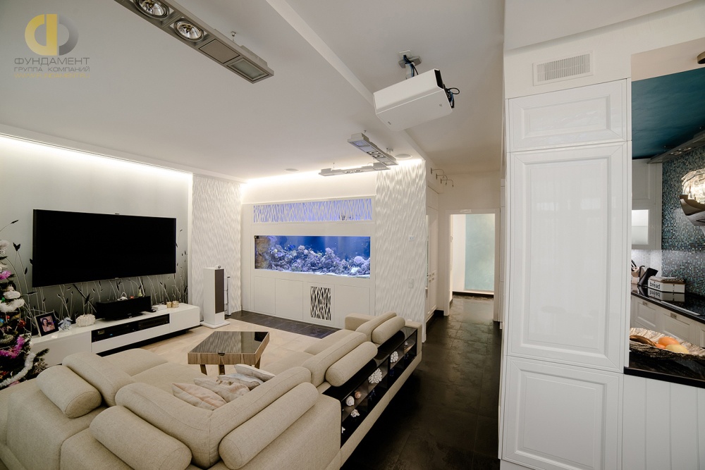 Белые фактурные панели и встроенный аквариум в декоре гостиной